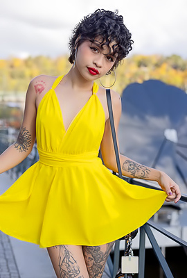Lilith Baph removes yellow dress, revealing her tattooed body and big ass